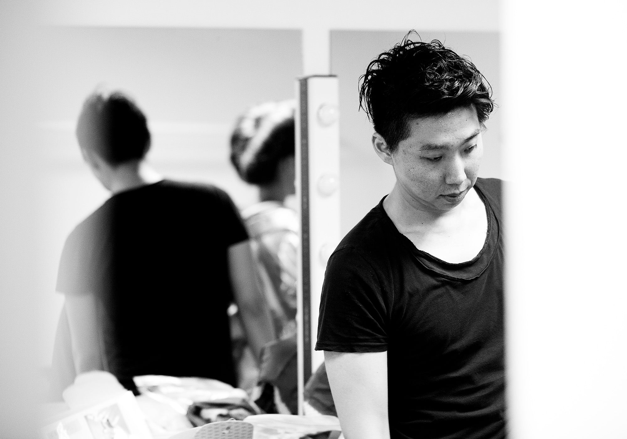 Kentaro Terauchi wearing a black t-shirt in a blurred indoor setting